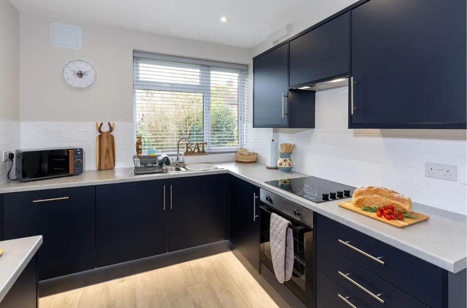 Large kitchen with oven, kettle, toaster and dishwasher