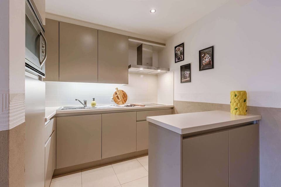 Modern kitchen with sleek surfaces and warm wooden accents.

