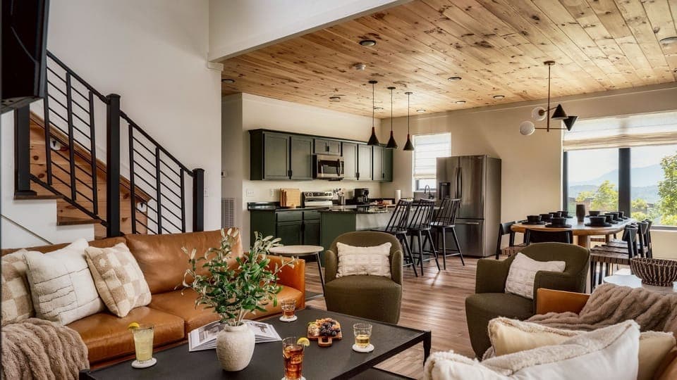 Large Cabin Rentals Smoky Mountain Sevierville Pigeon Forge Five - Main entry (middle level) living room, with modern, open kitchen, dining and living room. Living Room features gas fireplace, large SMART TV, and Wifi