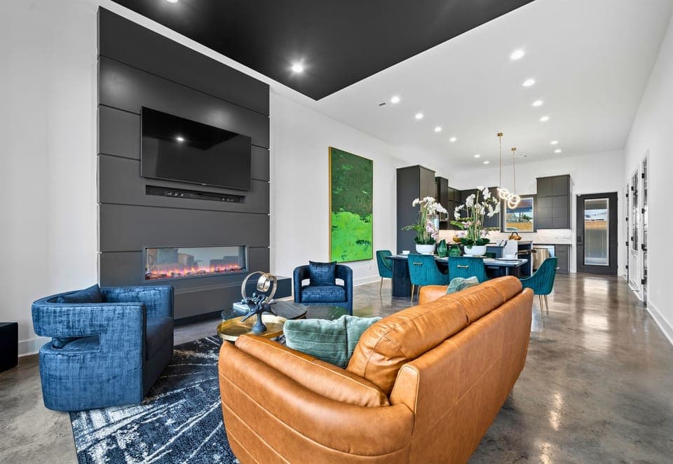 This spacious living room offers plenty of seating, modern decor, and a welcoming ambiance—perfect for spending quality time with family or friends.