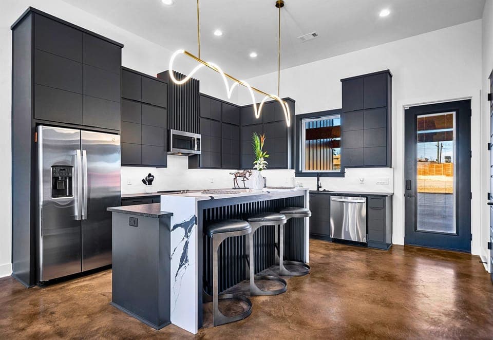 A seamless blend of elegance and functionality, this open-concept kitchen and dining area features sleek finishes, a spacious island, and thoughtful design touches.