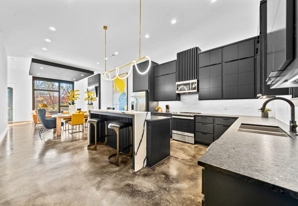 The open kitchen design balances function and style with modern appliances, sleek finishes, and plenty of room for cooking or entertaining.