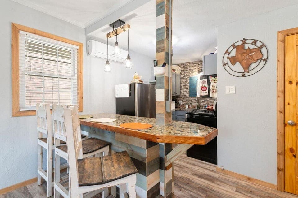 Beautifully designed bar with 3 high back wooden bar stools.