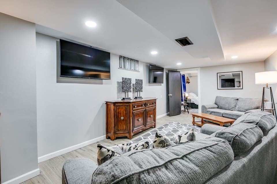 Downstairs living area with two 55in TVs. Two games on at once? You can watch both!