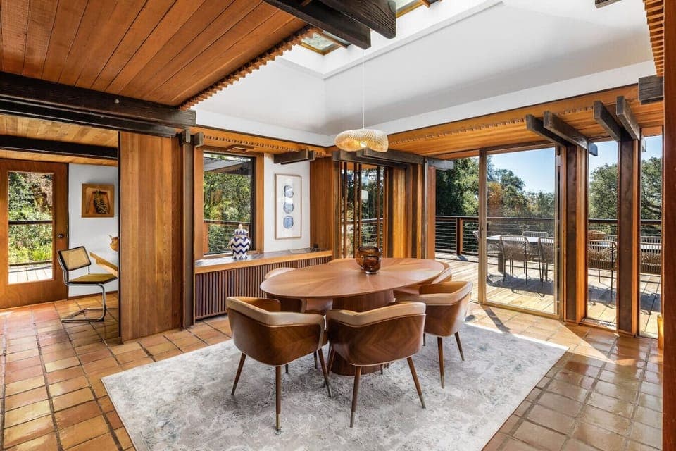 Elevate your dining experience in this stunning space with warm wood tones, modern lighting, and seamless indoor-outdoor flow—perfect for entertaining or intimate meals.