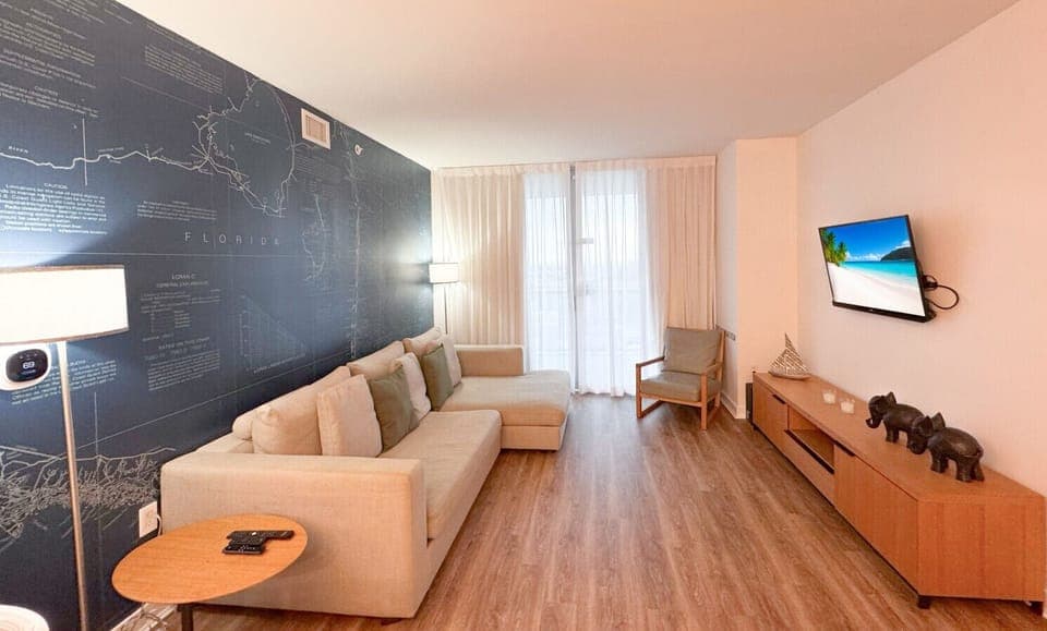 Bright living room with balcony access and city views.