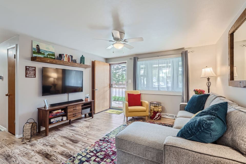 Living room with couch, reading chair, 50” Roku TV with apps