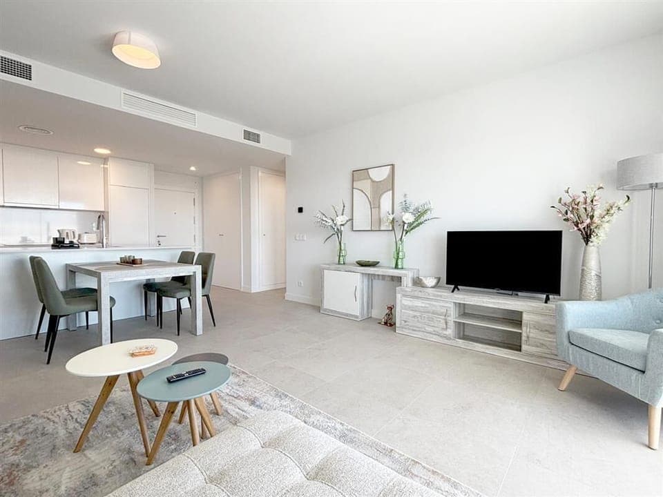 Lounge area with dining area for four guests and open kitchen to the rear