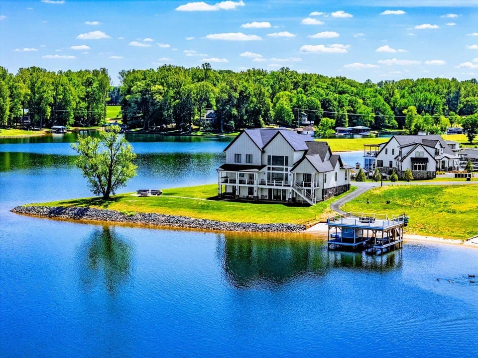 Backyard & Beach - Perched on its own private point, with water on three sides and a dock just beyond the lawn.