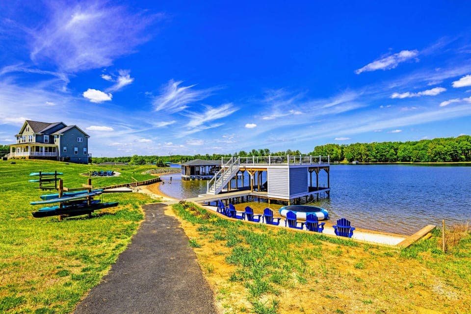 Backyard & Beach - The walk down: open lawn, kayak rack ready to grab and go, dock and chairs waiting at the water.