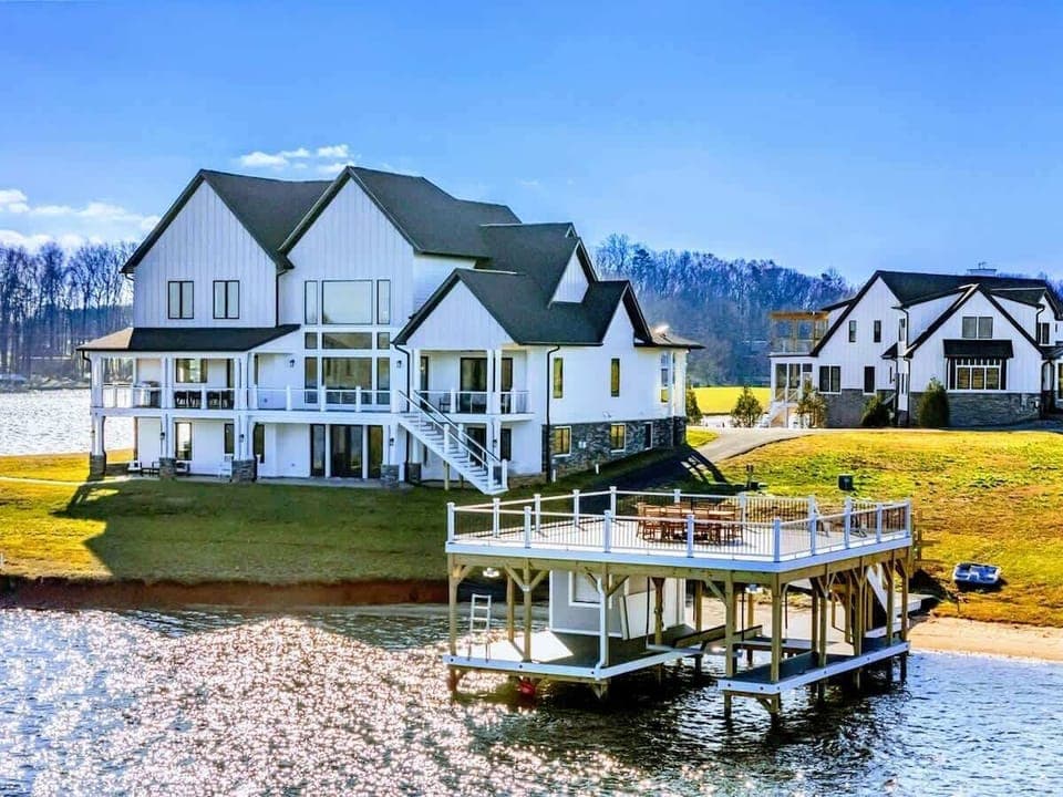 A stunning waterfront property features a spacious home with a private dock and panoramic views of the lake, perfect for relaxation and outdoor enjoyment.