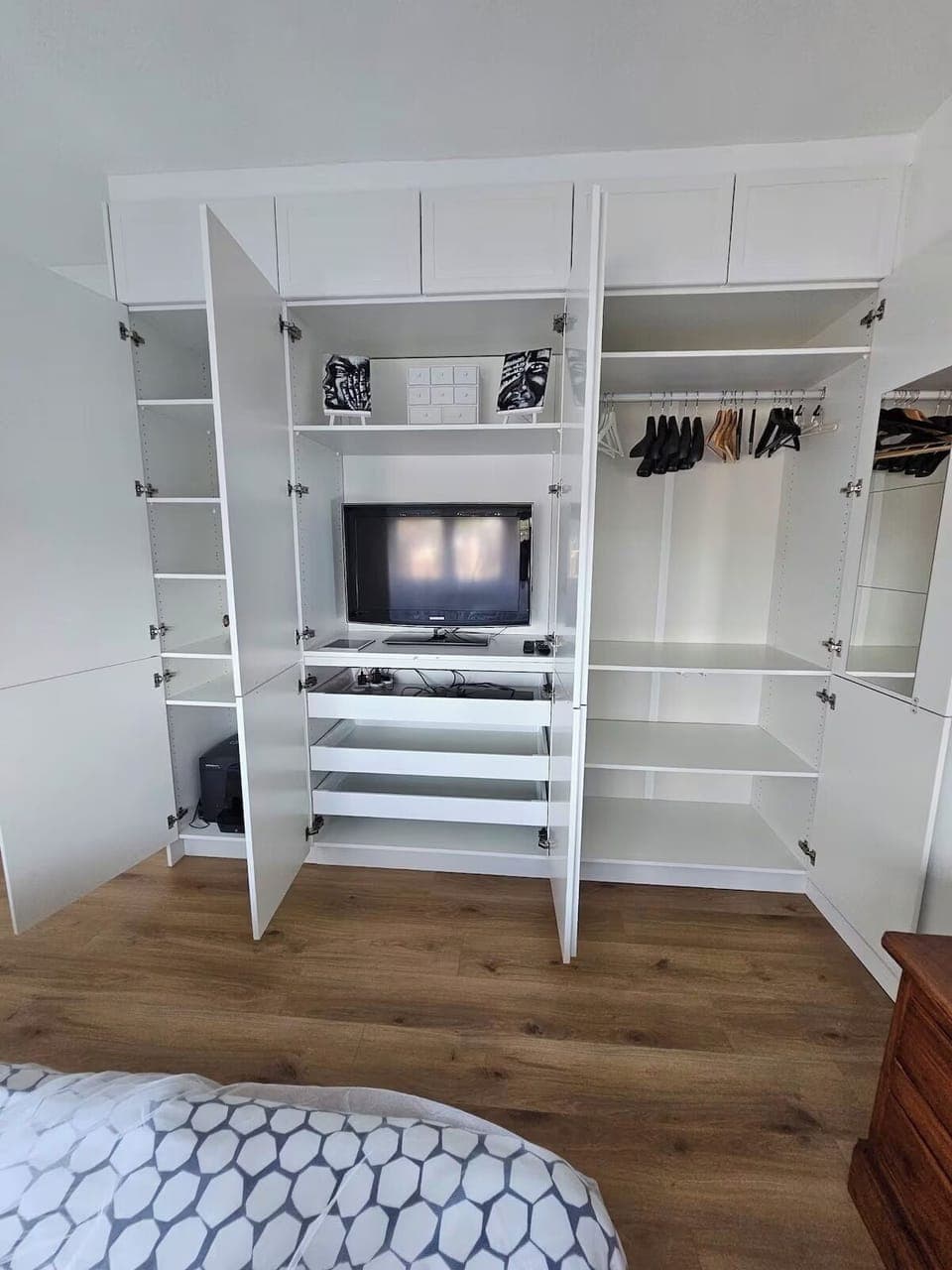Built-in dressing cupboard in master bedroom with second TV