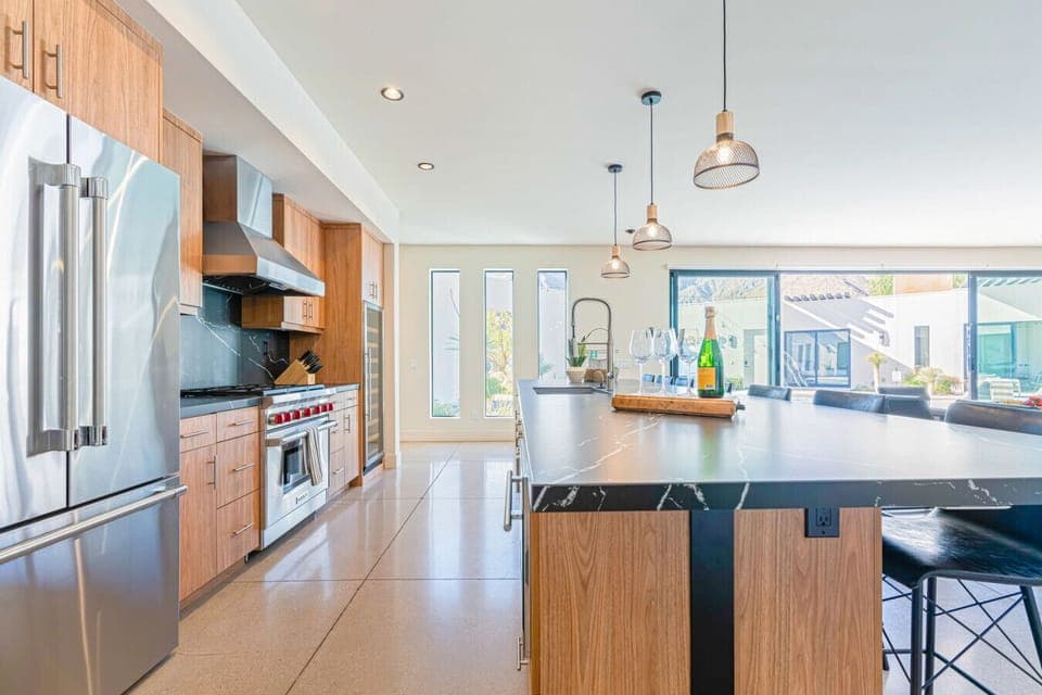 Open kitchen & dining area w/ spacious counters, warm wood tones, and an easy flow into the living space.