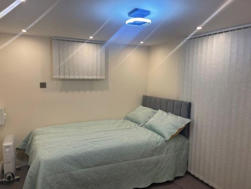 Relax and recharge in this serene bedroom featuring a comfortable bed. 