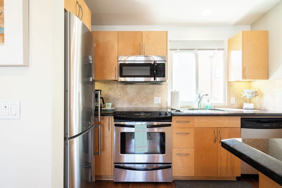 Full chef's kitchen with stainless steel appliances.  All pots and pans, dishes, equipment needed