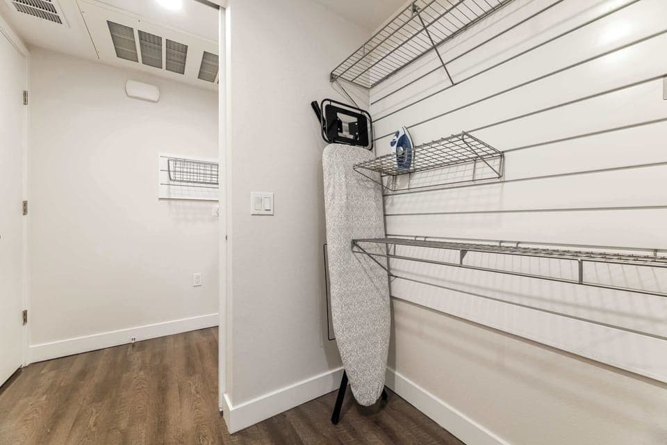 Bright dressing corridor, designed for convenience and comfort with modern shelving — ideal for extended stays and effortless organization.