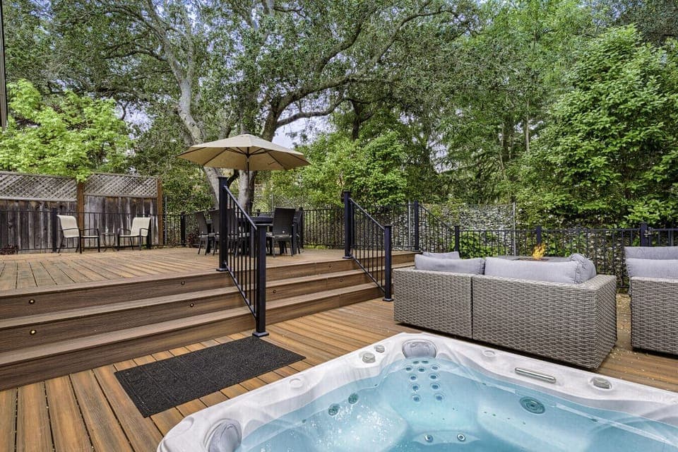 Wraparound deck with hot tub, fire pit, seating, grill, and amazing views