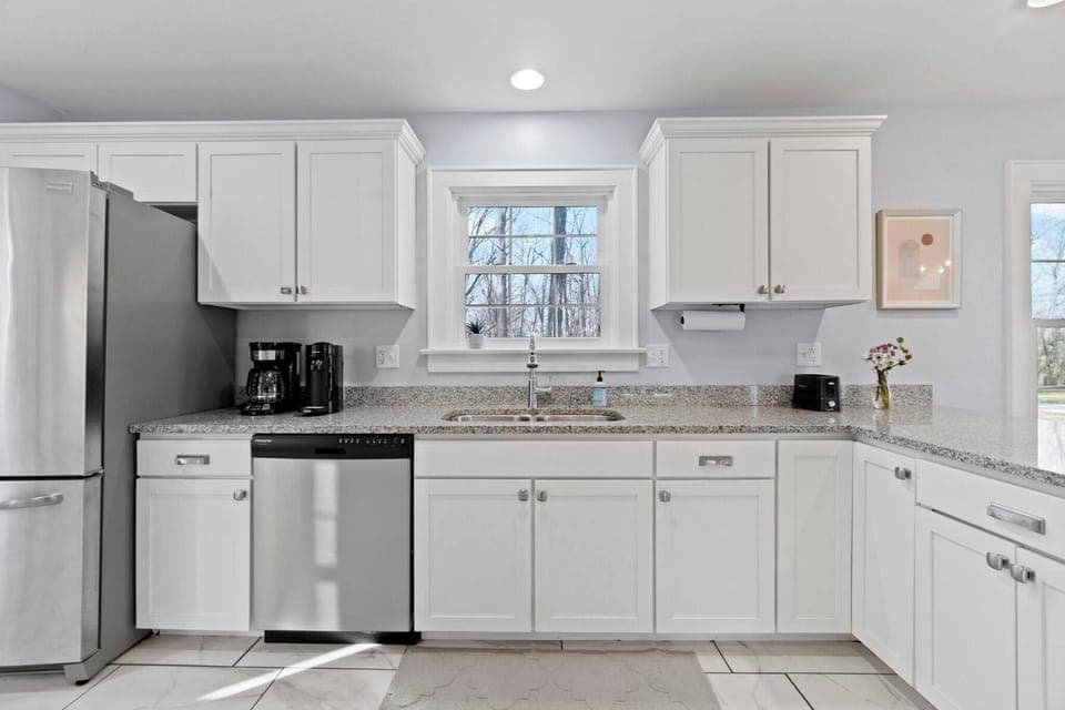 Bright, spacious, and well equipped-- this kitchen is the perfect place to cook relax, and enjoy your stay!  Has a dishwasher for added convenience. 