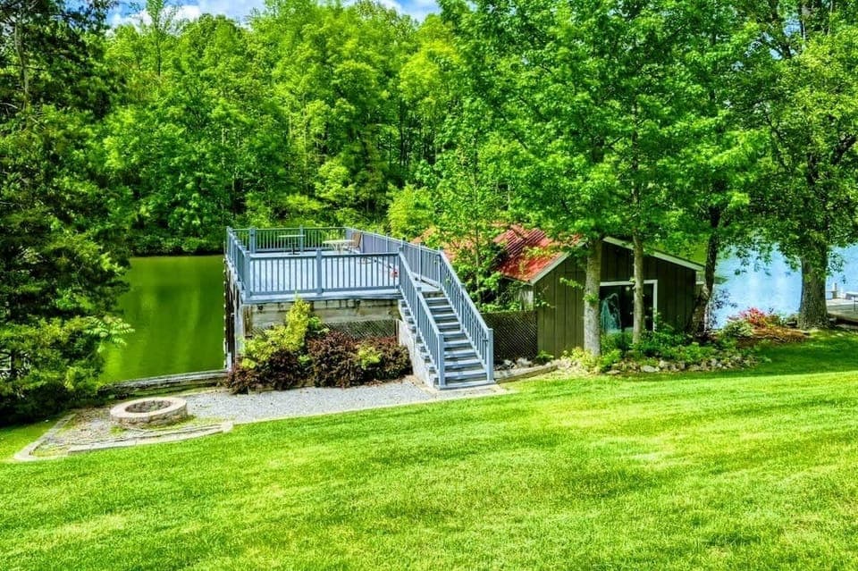 Discover your private retreat overlooking the serene shores of Lake Anna, with a charming deck nestled amidst lush greenery.