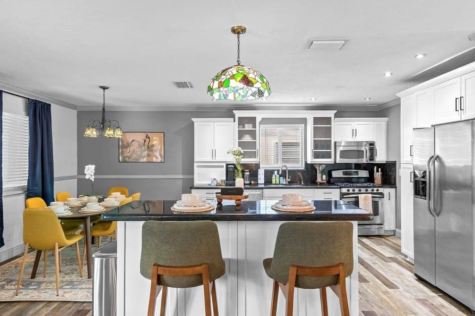 Kitchen with bar seating for 2 and the dining area is at the left