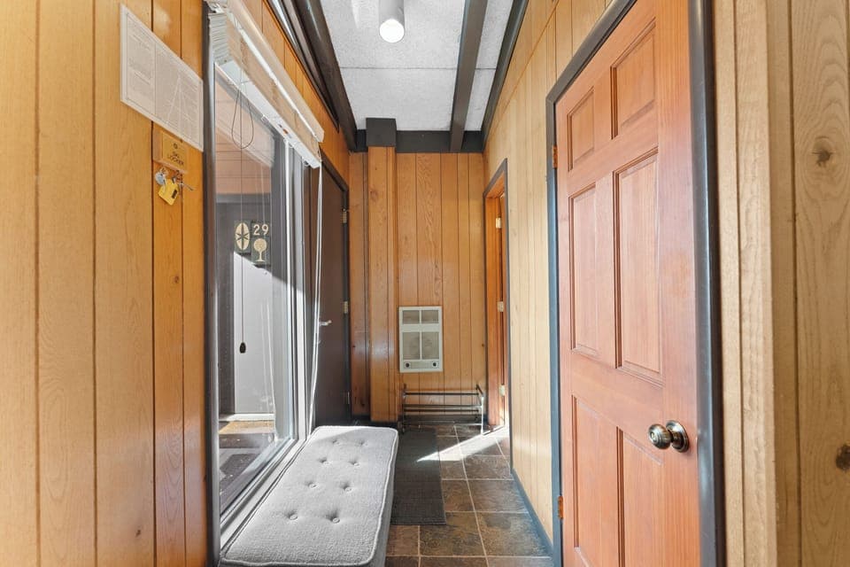 Unit entryway with a bench and shoe rack for added convenience.