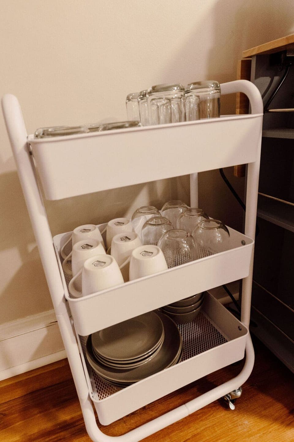 Tea and coffee mugs await on this charming beverage cart.