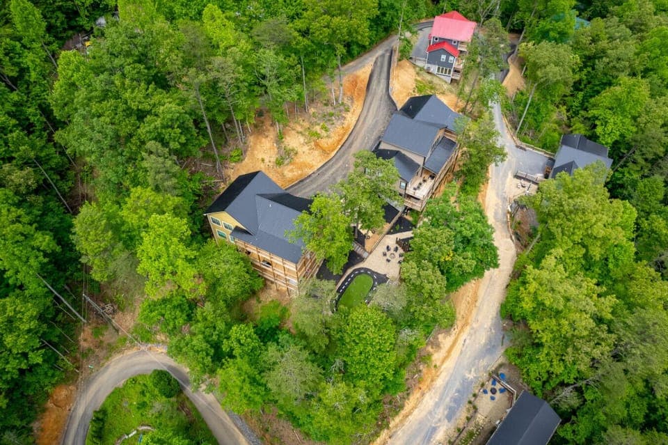 Summit Luxe Resort—two side-by-side luxury cabins with a shared garden, sparkling pools, and breathtaking Smoky Mountain views.