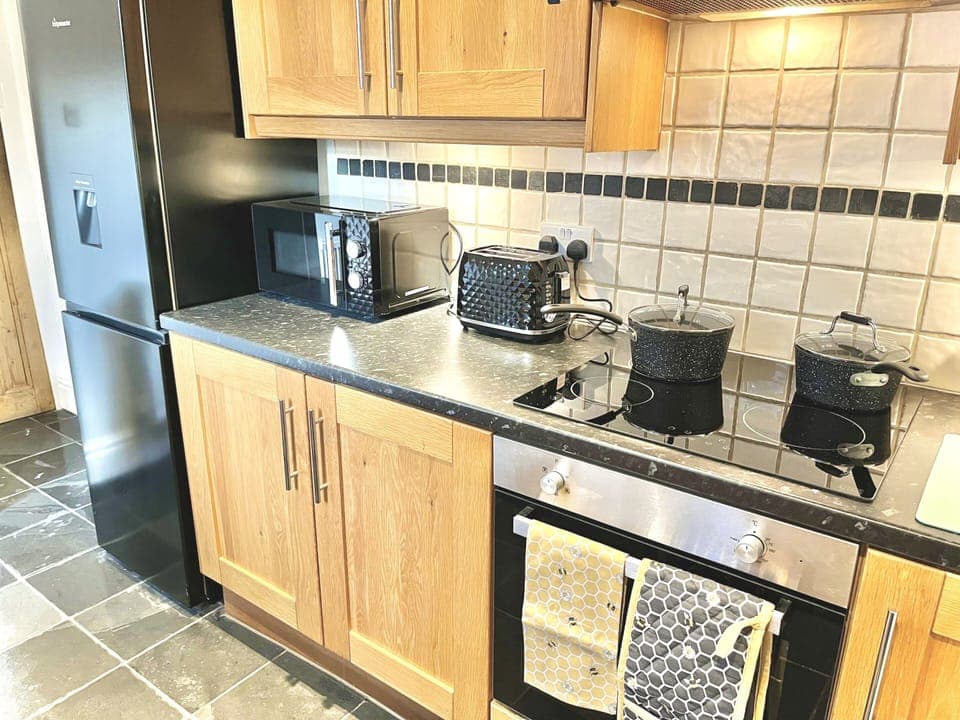 Kitchen - Well equipped with electric hob, fan assisted oven & grill, microwave, toaster, kettle and fridge freezer
