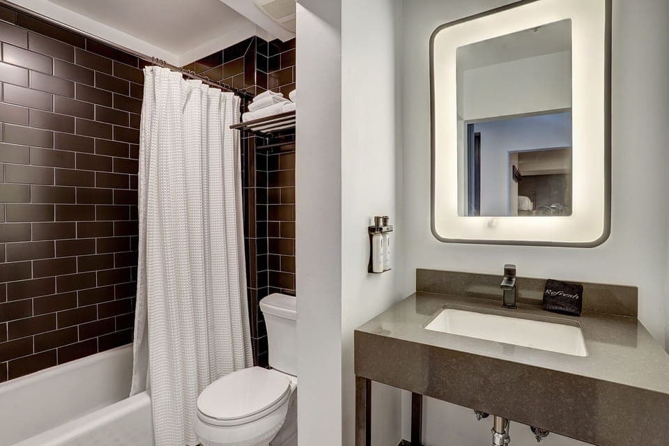 Sleek and modern bathroom with elegant finishes, offering a refreshing retreat with a spa-like ambiance.