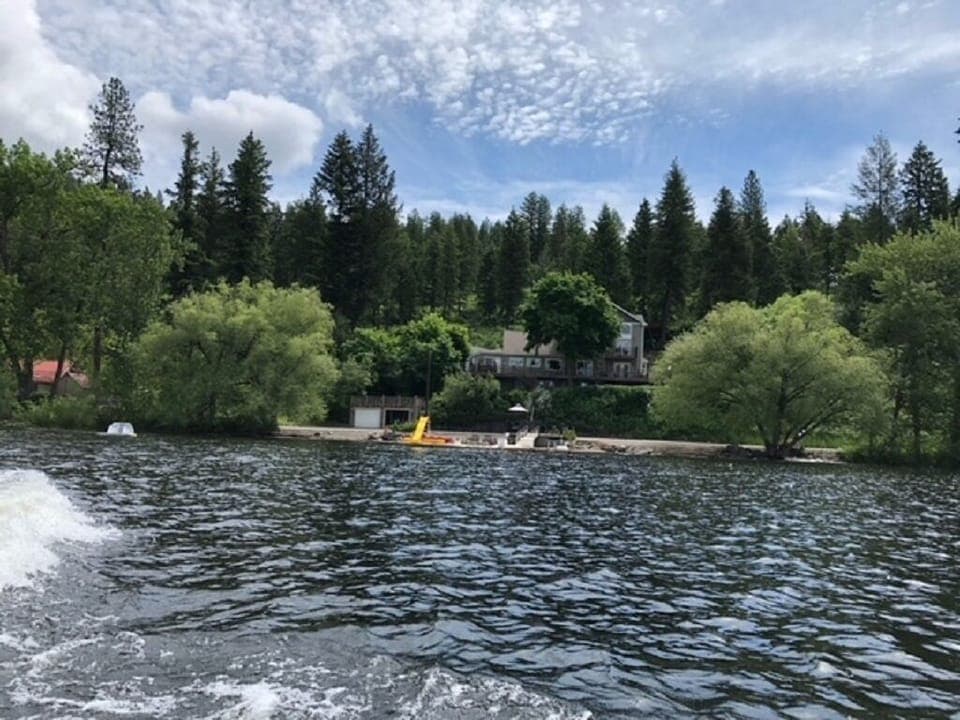 Front view of the home, beach and dock. 