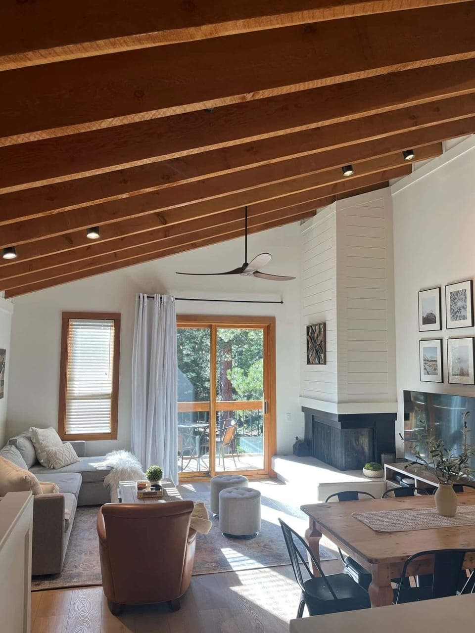 Open Living space with pull out sofa, TV, fireplace, and balcony