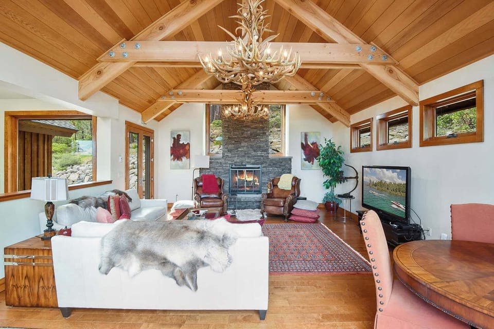 Luxurious living room with wood burning fireplace, flat screen TV