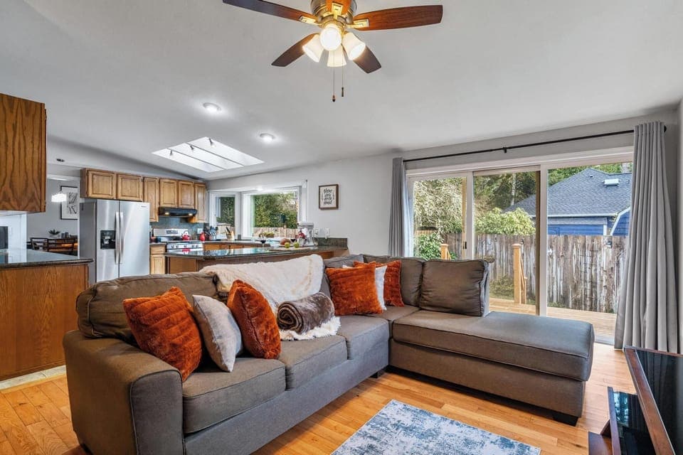 Snuggle up in the family room, just off the kitchen. Here you can watch tv, warm up by the woodstove, or simply enjoy the views of the backyard. 