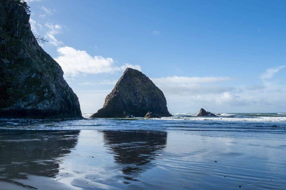 1. Stunning coastal getaway! Steps from the beach! This crming home (marked with a red arrow) is nestled among the trees and breathtaking ocean views. Enjoy peaceful surroundings, easy beach access, and the beauty of nature ri