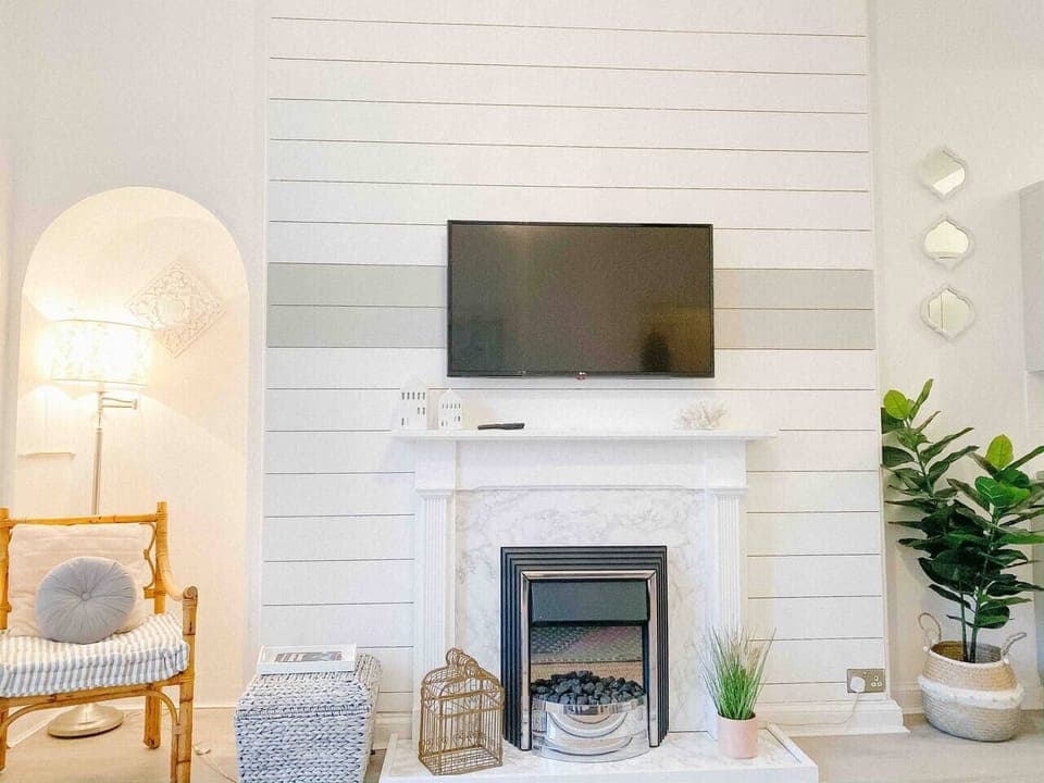 Cosy living room with electric fireplace.