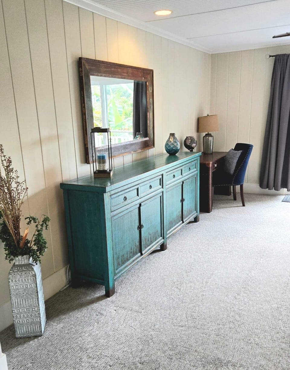 - Elegant dresser with mirror adds charm to master bedroom   - Workspace desk provides a spot for writing or remote work   - Decor accents and soft carpet create a relaxing retreat
