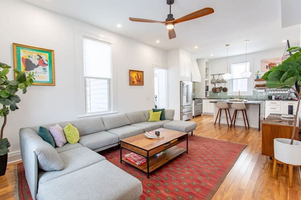 A comfortable living area with a seamless view of the kitchen on the side, offering an open and connected space for relaxation and easy access to dining.