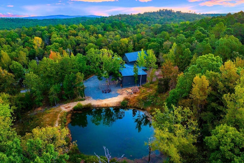 A few steps from the cabin, your private stocked pond awaits — peaceful mornings, fishing poles, and reflection guaranteed.