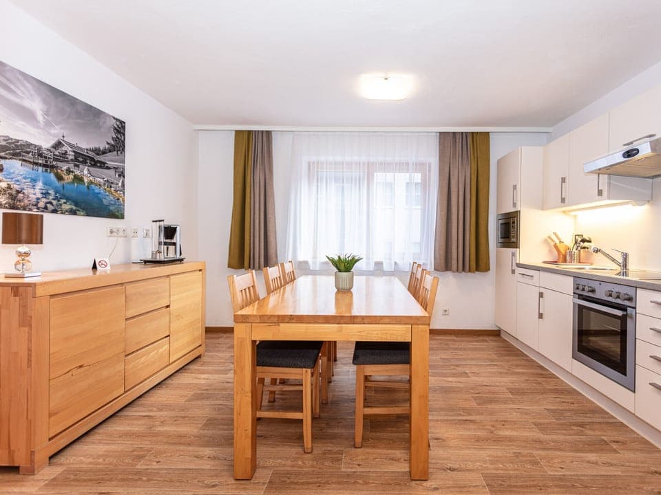 Dining room in Appartements Hollin by we rent apartments in Saalbach, with a table, and chairs. Mountain view.
