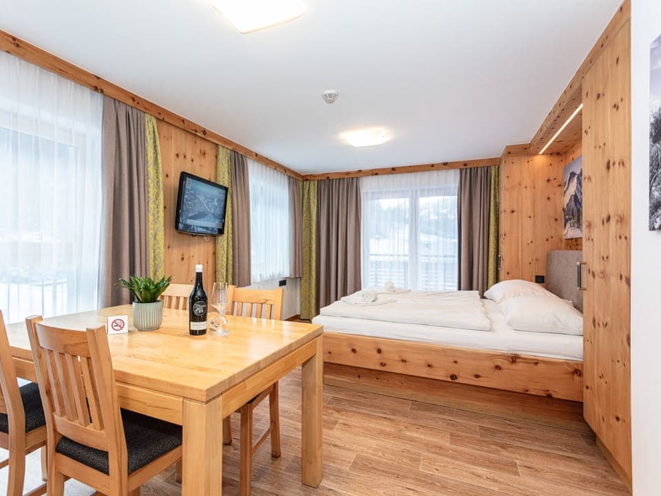 Bedroom in the holiday apartment Appartements Hollin in Saalbach by we rent apartments, featuring a cozy double bed.