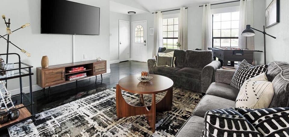 Relax in this bright, airy living room with plush sofas, a modern entertainment system, and cooling ceiling fans—perfect for unwinding after a day at Old Settlers Park or Kalahari Waterpark!