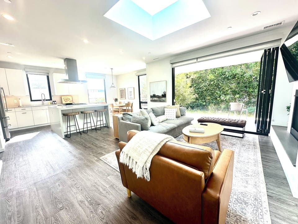 Open concept great room with folding la cantina doors to covered patio