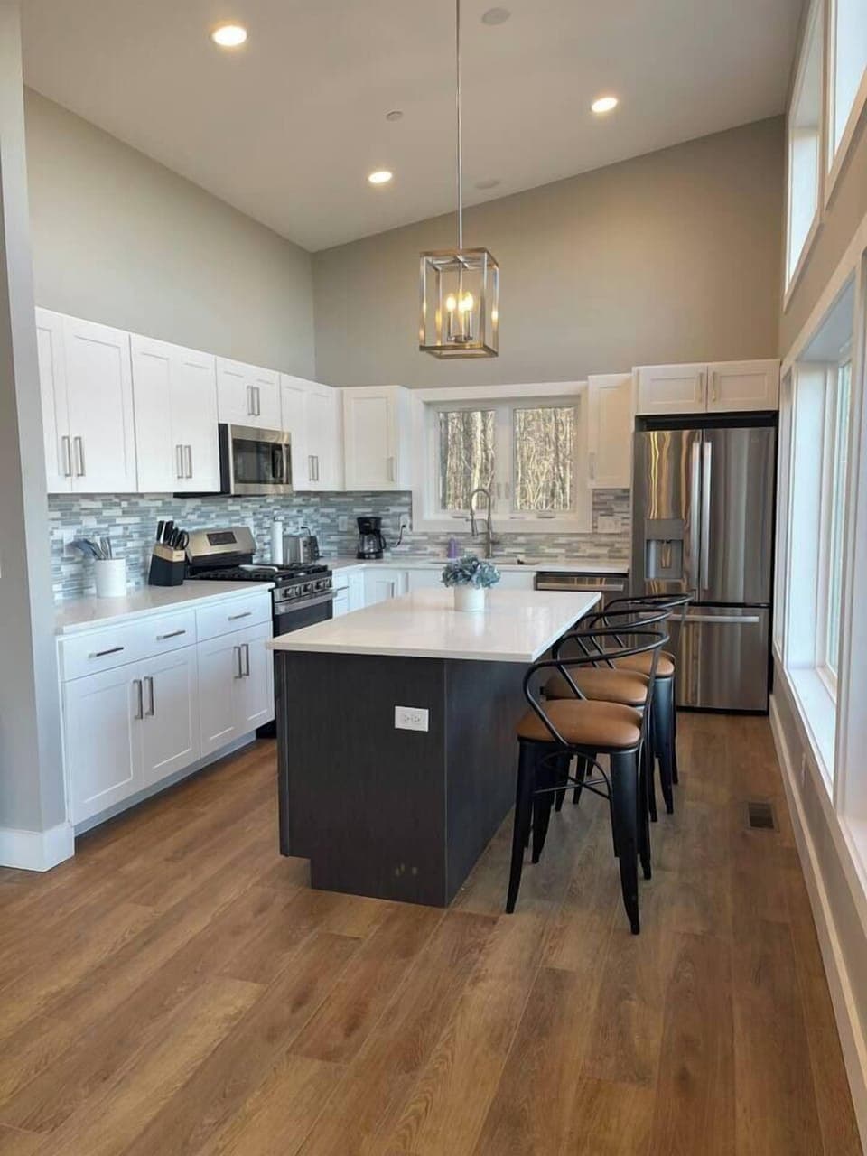Spacious modern kitchen with island and stools