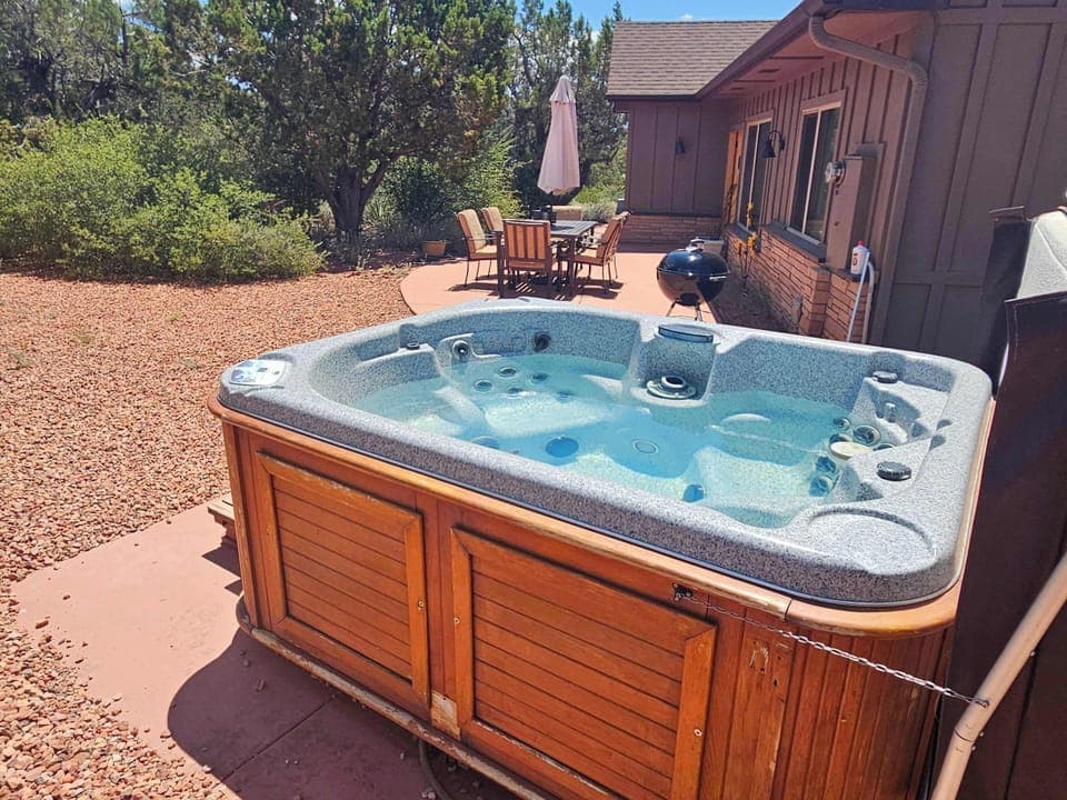Relax in the outdoor hot tub, nestled in the backyard patio.