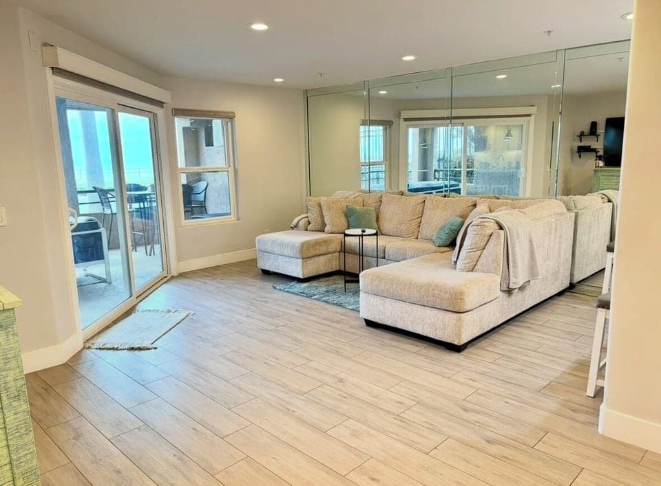 Large, sunlight filled living room, cozy beachy vibes, automatic blackout blinds