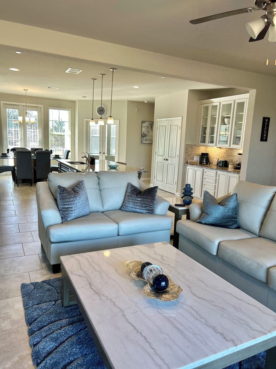 Large living room with leather sofas and 65in  smart tv .