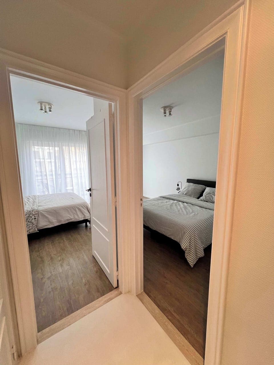 Hallway connecting both bedrooms with natural flow
