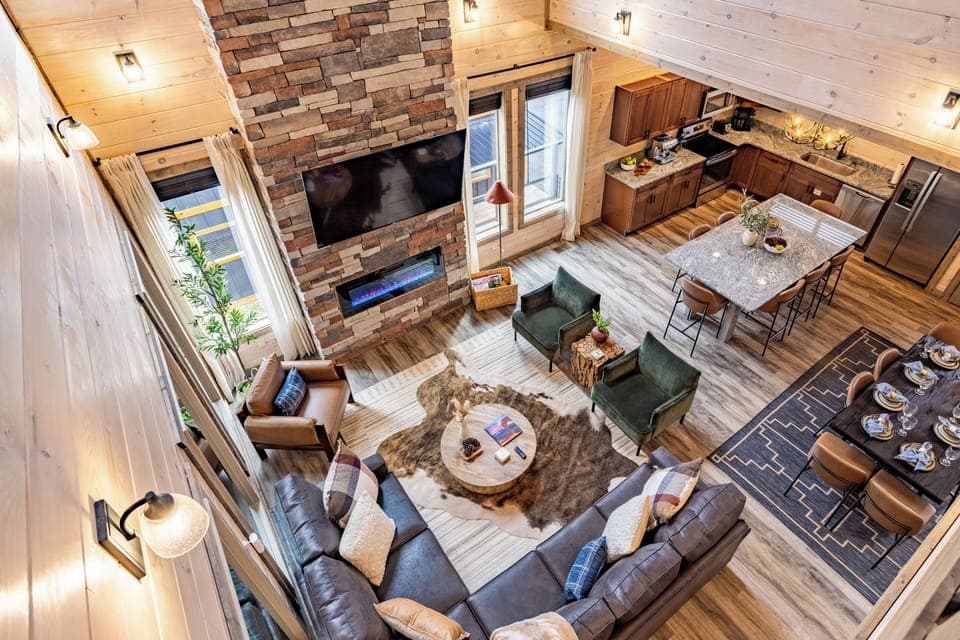 Spacious open-concept living with fireplace, full kitchen & dining for family.