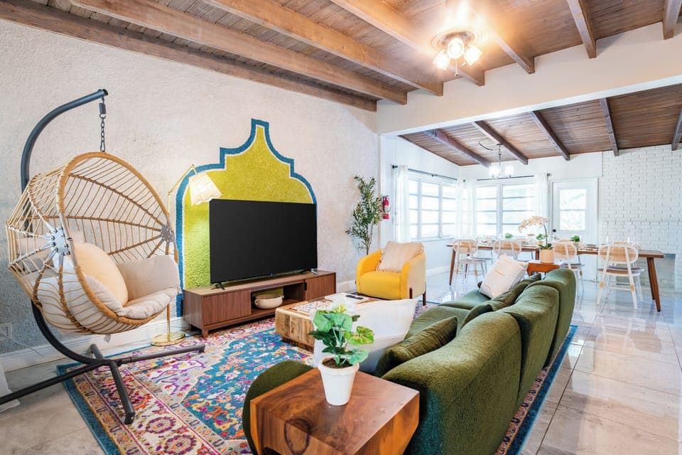 Cozy living room with egg chair, plush couch, and TV