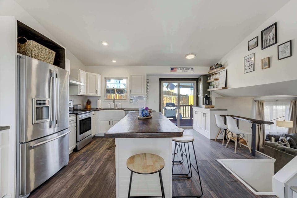 Bright and stylish kitchen with stainless steel appliances, a large island, and seamless access to the outdoor deck!




